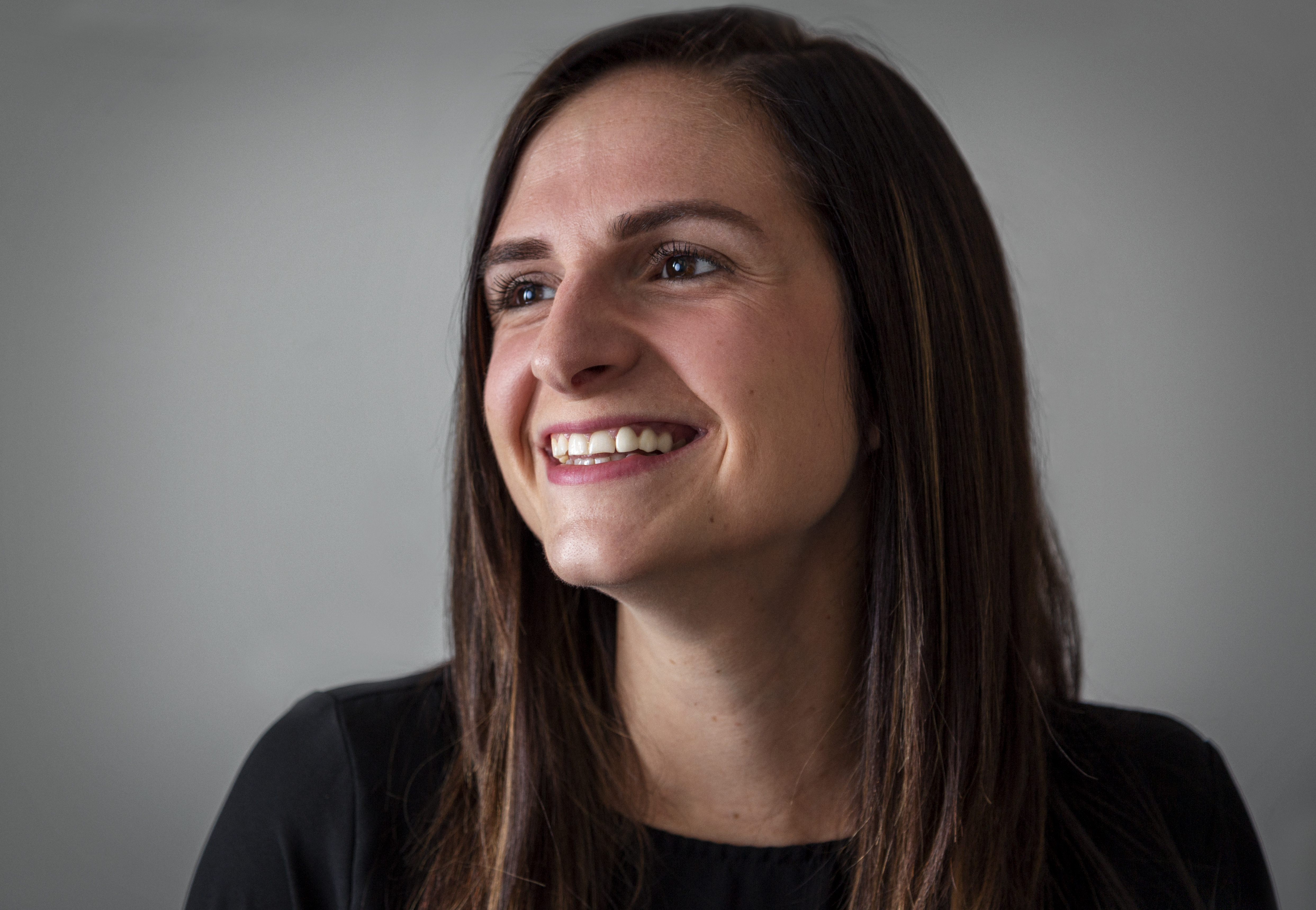 woman looking to the left smiling