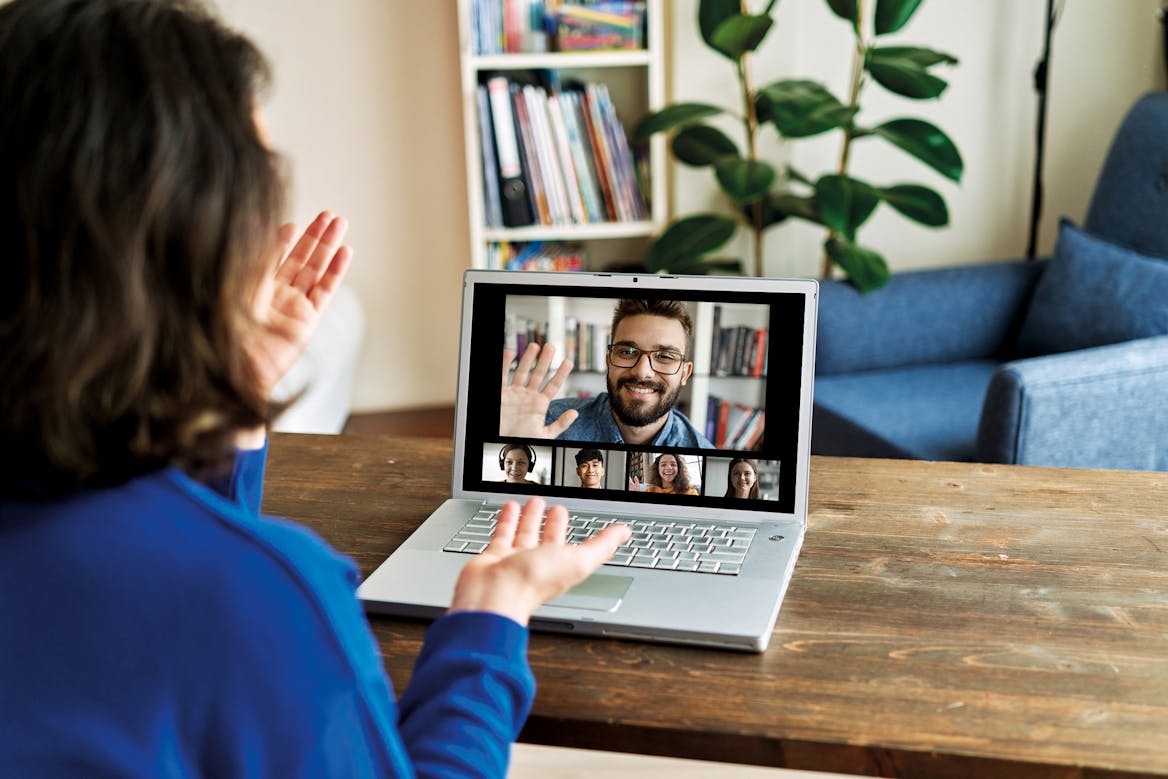 Person sitting in their living room at a desk taking an online class with 4 other people Person sitting in their living room at a desk taking an online class with 4 other people
