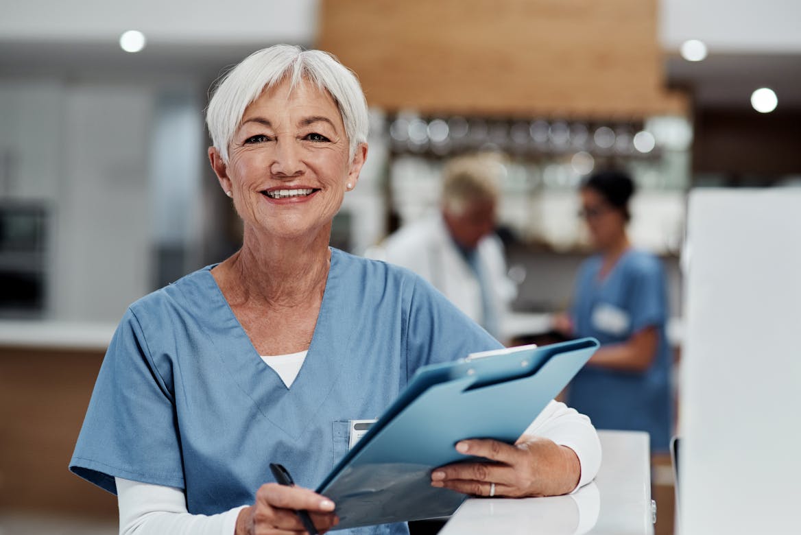 experienced nurse in hospital holding clipboard experienced nurse in hospital holding clipboard