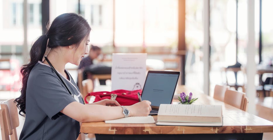 nurse sitting at desk studying nurse sitting at desk studying