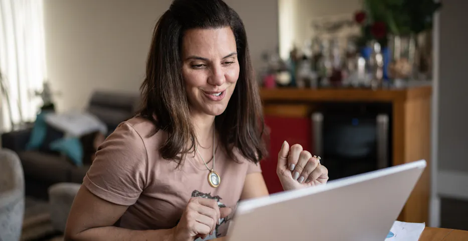 Woman speaking with someone on a laptop Woman speaking with someone on a laptop