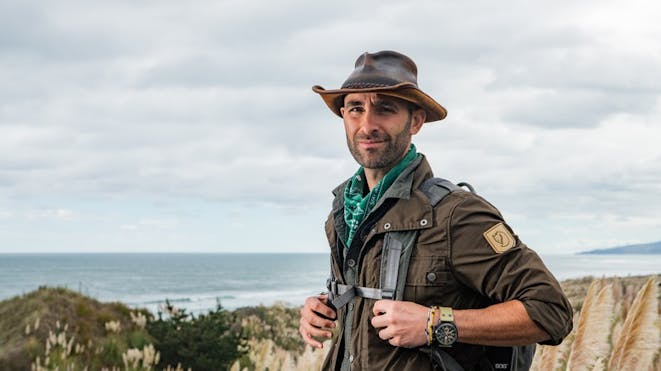 Coyote Peterson sitting on a rock