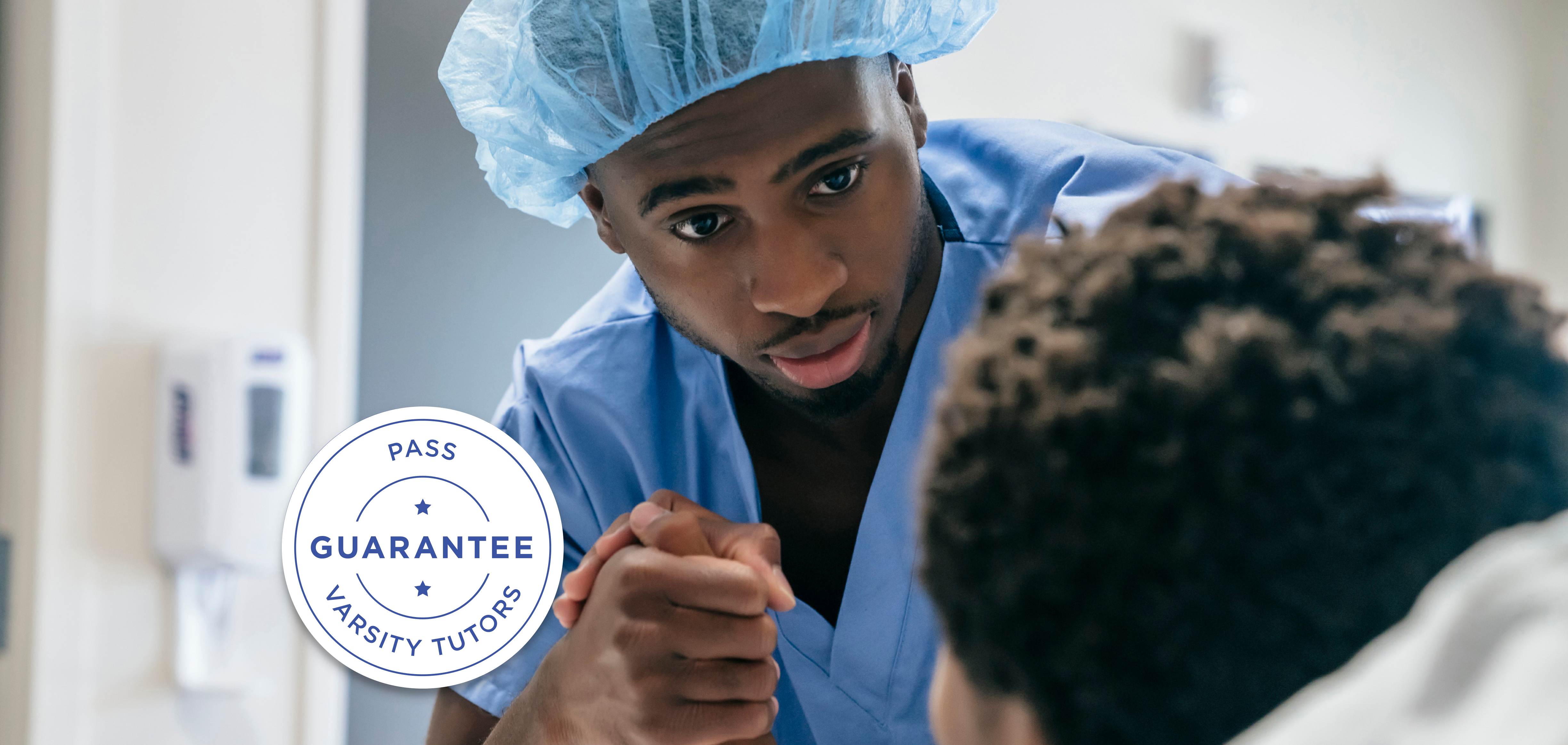 Nurse holding patient's hand in hospital