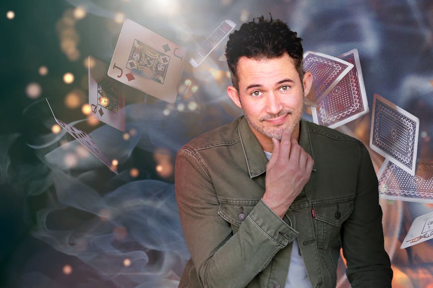 Justin Willman with cards behind him