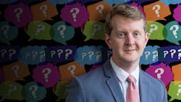 Ken Jennings in front of colorful question marks Ken Jennings in front of colorful question marks