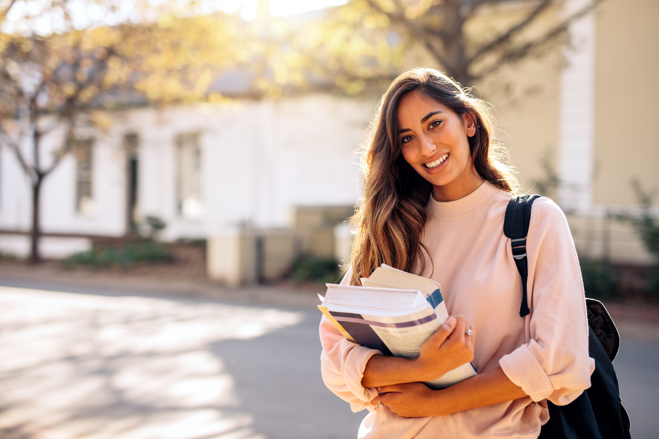 woman holding textbooks