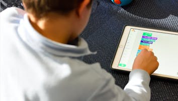 a child working on block coding a child working on block coding