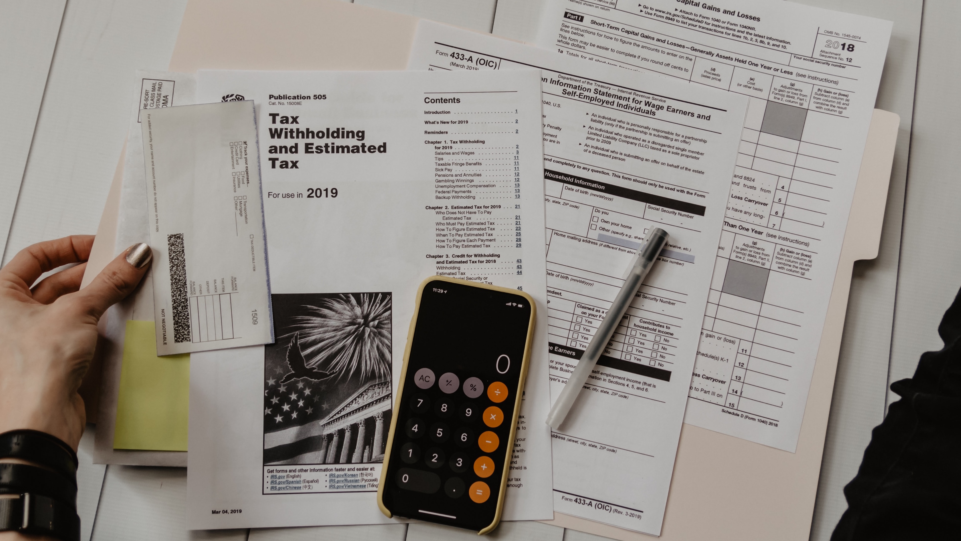 tax forms, papers, and folders on a table
