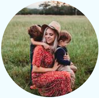 Mom kneeling with two children