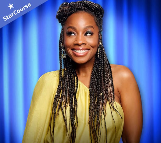 Anika Noni Rose in front of a blue curtain Anika Noni Rose in front of a blue curtain