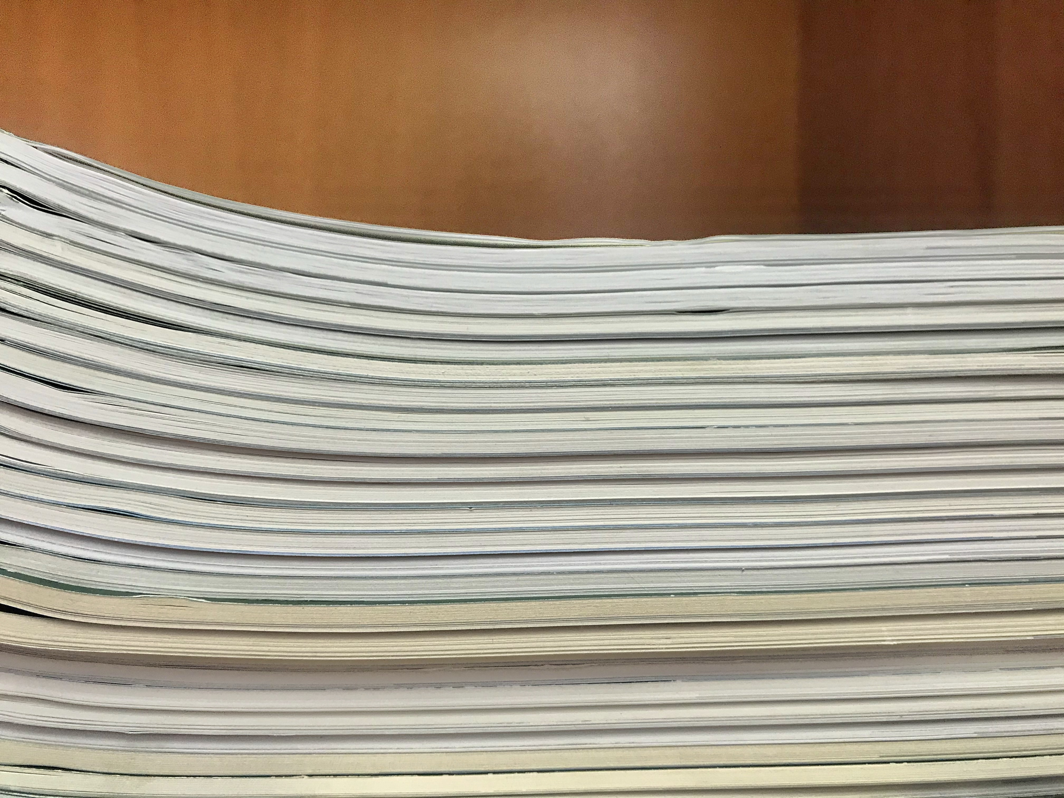 Stack of test booklets against a wooden background