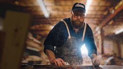 Ben Napier sawing through a piece of wood Ben Napier sawing through a piece of wood