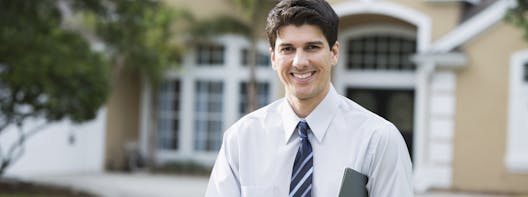 a realtor sitting in front of a house a realtor sitting in front of a house