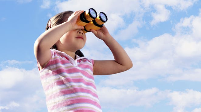 Child looking through binoculars 