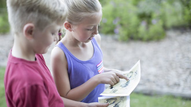 Children reading a map Children reading a map