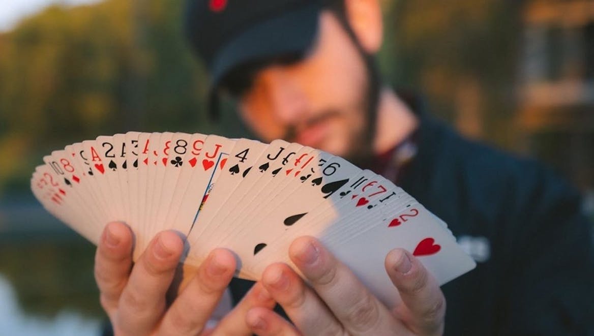 Hands holding a deck of cards Hands holding a deck of cards